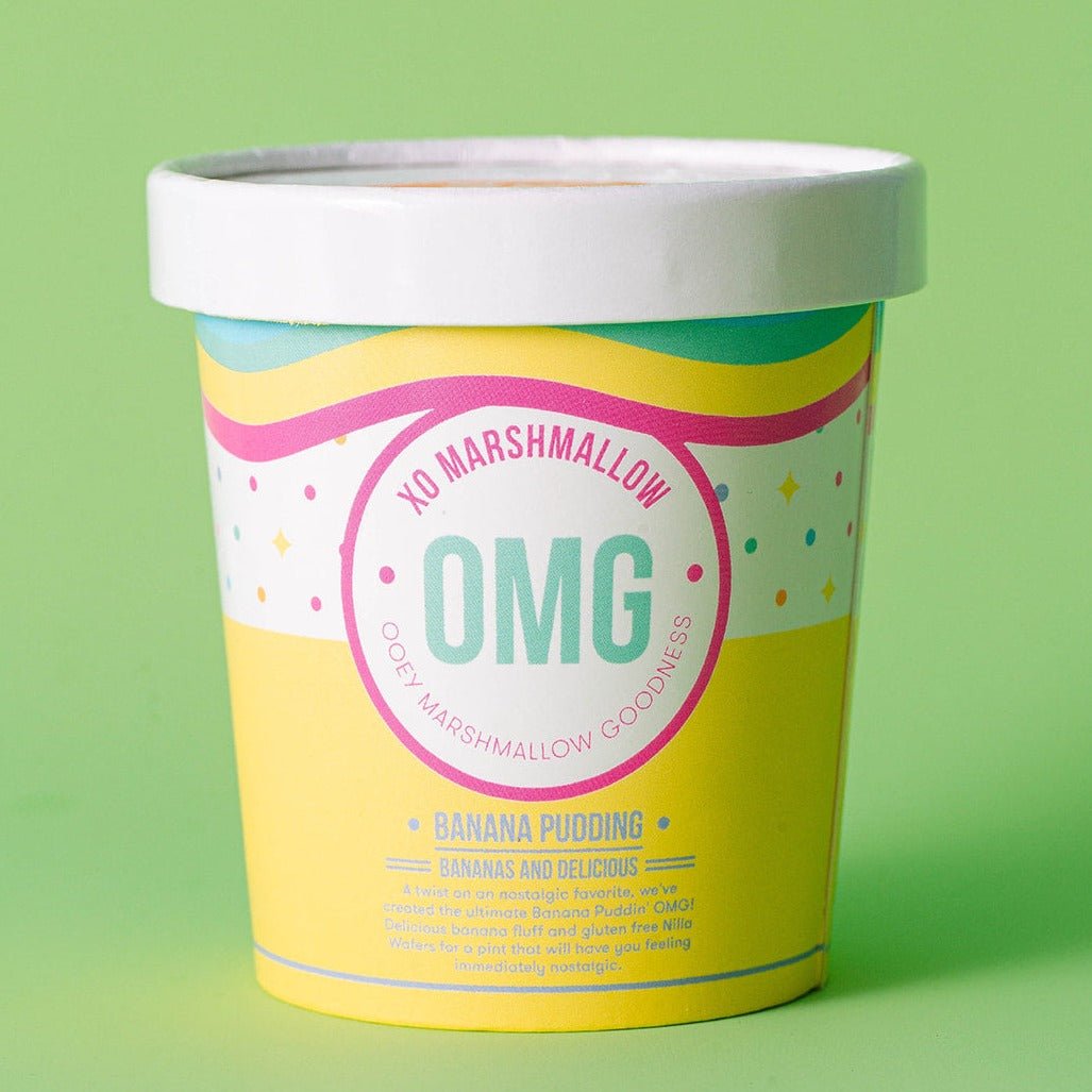 A photo of the banana pudding ooey marshmallow goodness's packaging. It's a yellow ice cream pint with a white lid that says "XO Marshmallow OMG ooey marshmallow goodness" against a light green backgorund.