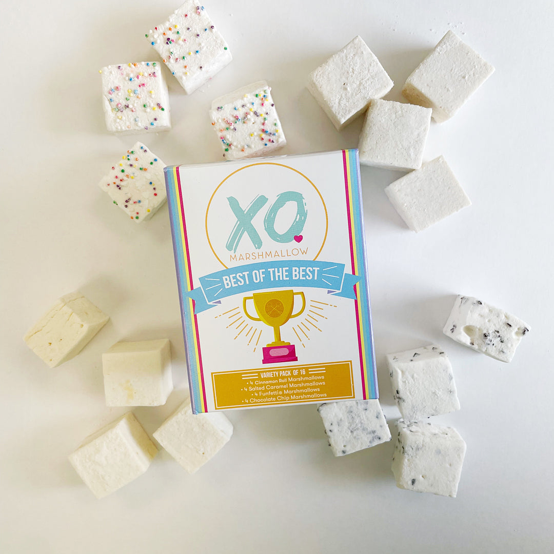 A variety of marshmallows including cinnamon roll, chocolate chip, salted caramel, and funfetti flavors, displayed around the packaging that reads 'XO Marshmallow' with a title 'Best of the Best'.