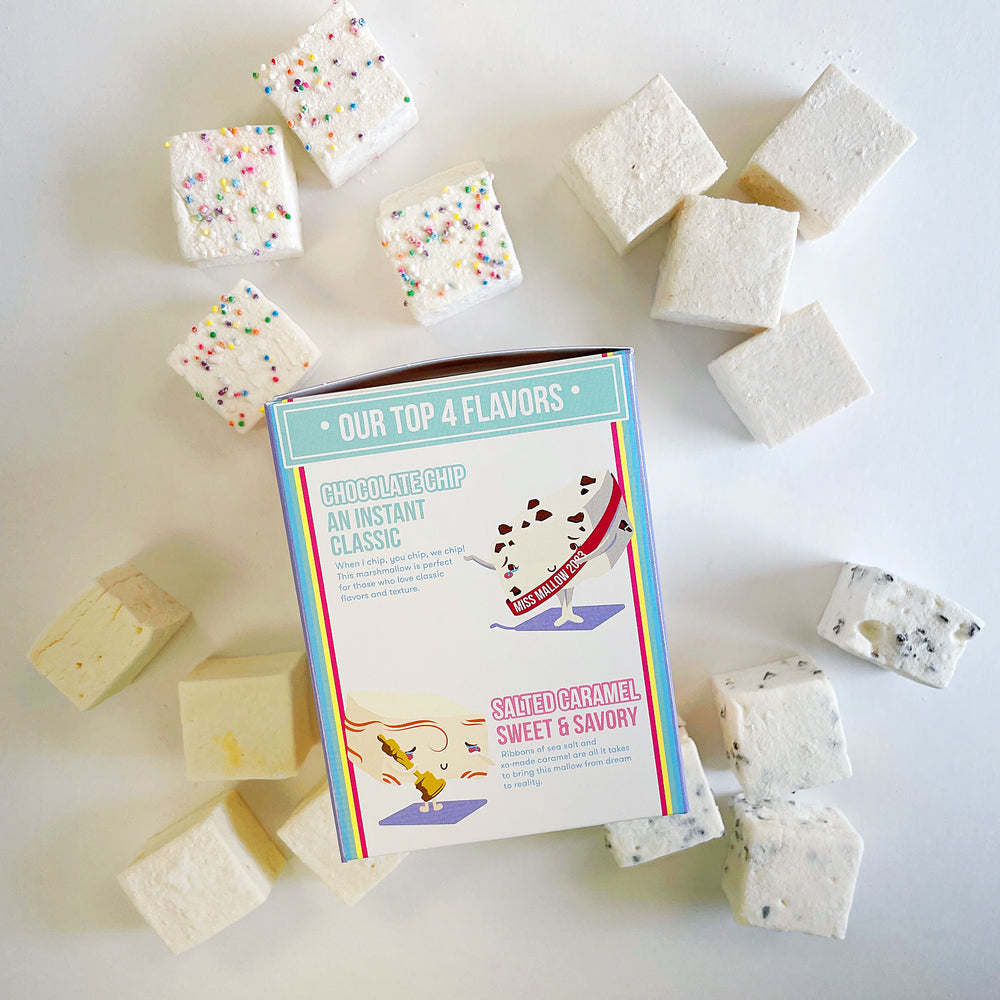Funfetti, Cinnamon Roll, Salted Caramel and Chocolate Chip marshmallows laid out around the side of the XO Marshmallow Best of the Best variety pack packaging that features a cute drawing of chocolate chip and salted caramel marshmallows.