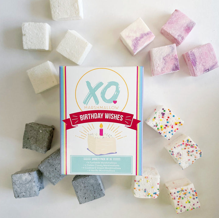 A variety of colored marshmallows arranged around the packaging labeled 'XO Marshmallow Birthday Wishes'.