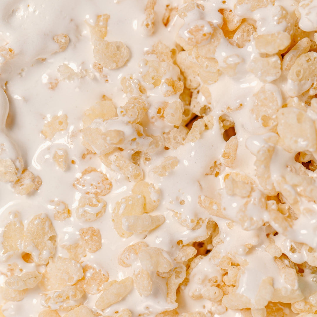 Close-up of a XO Marshmallow gluten free classic rice krispy treat (known as a marshmallow dream bar) with details showing their gooey vanilla marshmallow fluff inside of the cereal pieces 
