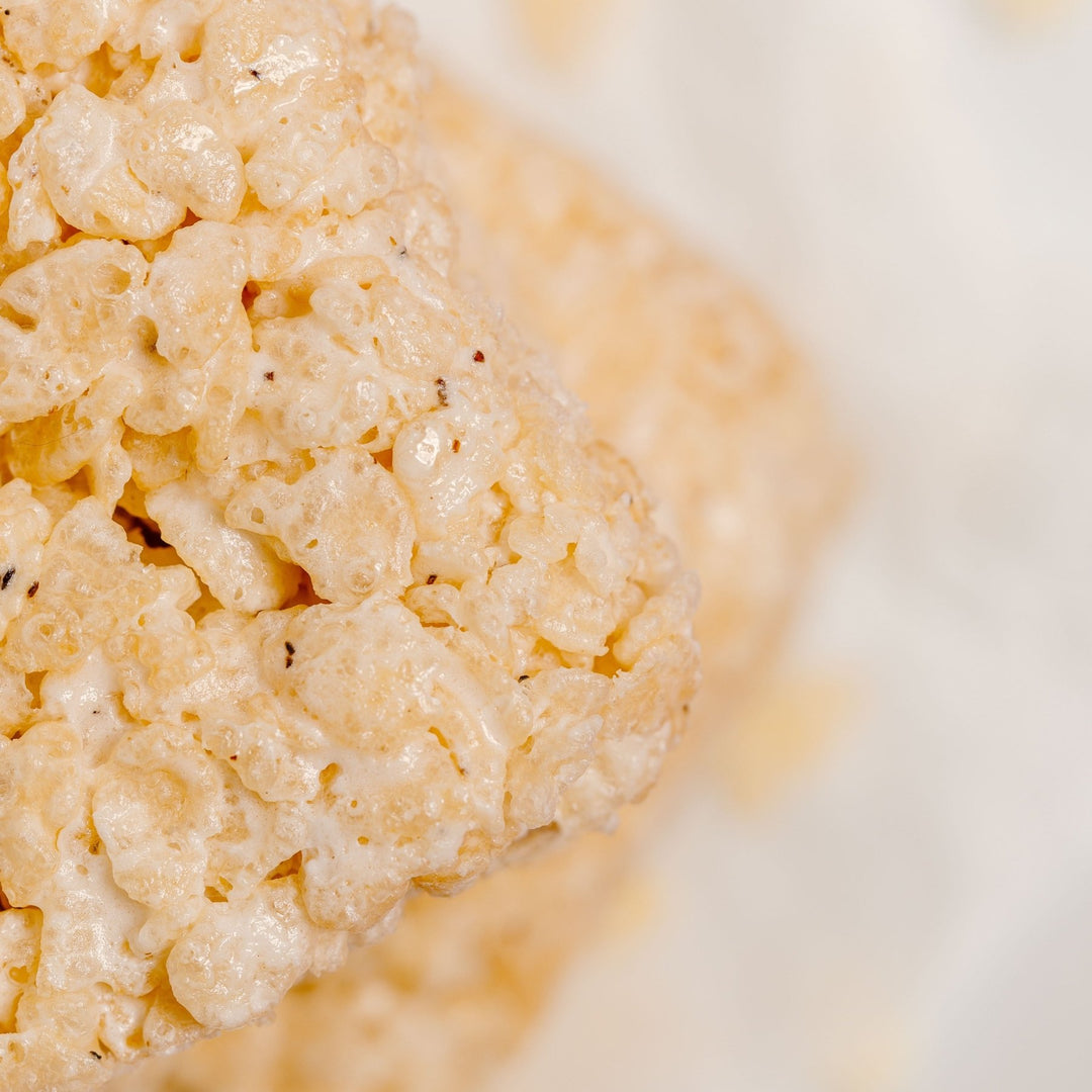 Super close up of a gluten free bite sized rice crispy treat from XO Marshmallow showing the flecks of vanilla bean inside of the treat