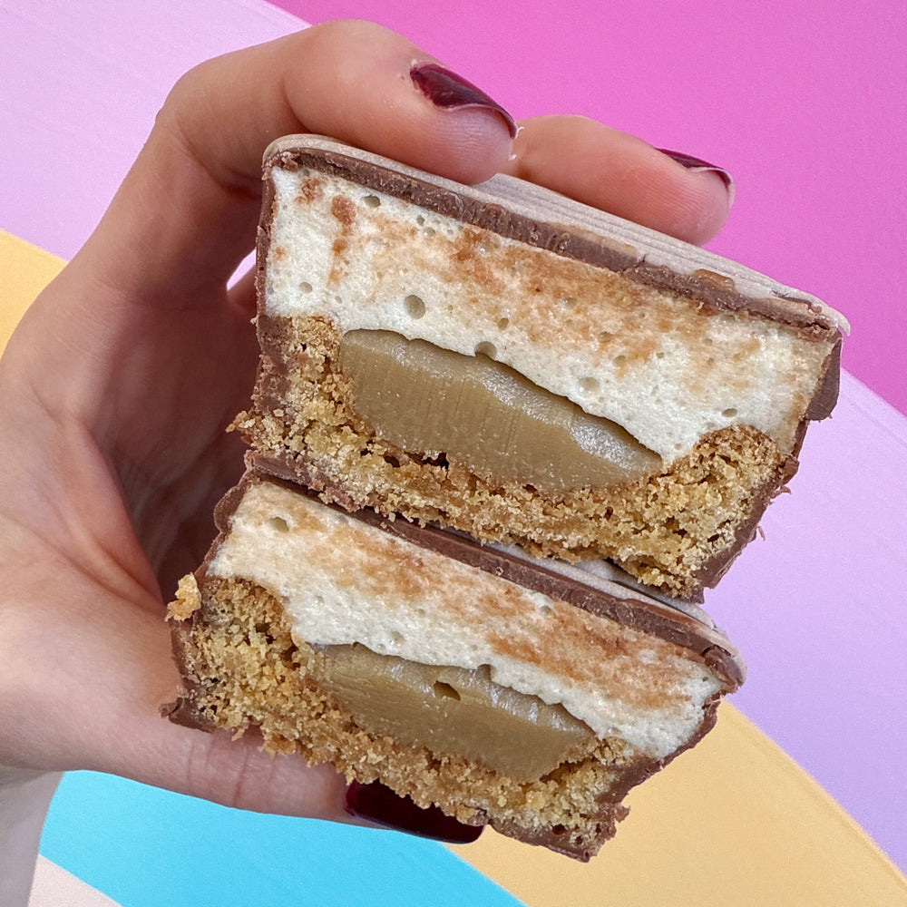 A cross section of our fluffernutter treats showing the inside cookie, ganache, mallow and milk chocolate layer. Looks like a peanut butter cup without the peanut butter!