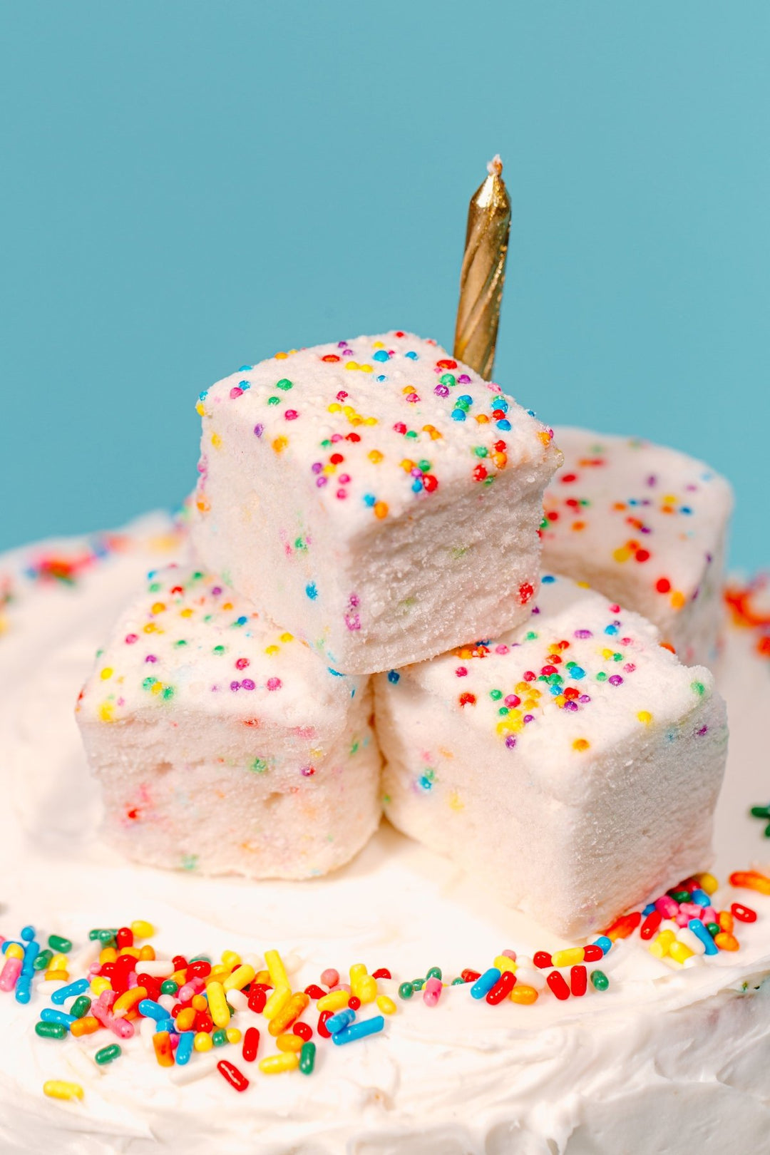 A stack of funfetti marshmallows on top of a birthday cake - featuring them as a best selling marshmallow flavor
