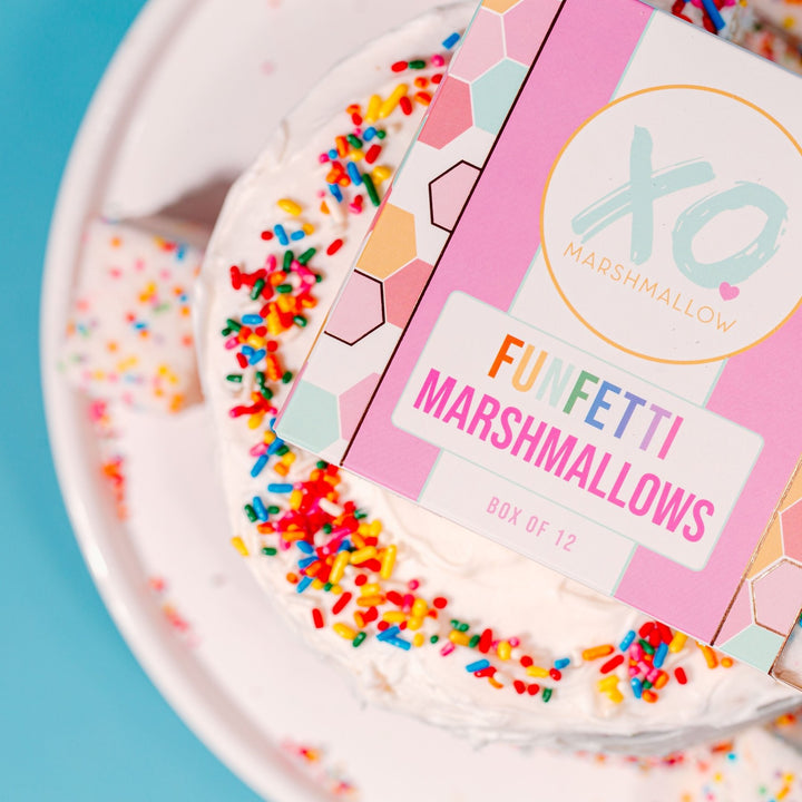 A box of funfetti marshmallows on top of a birthday cake