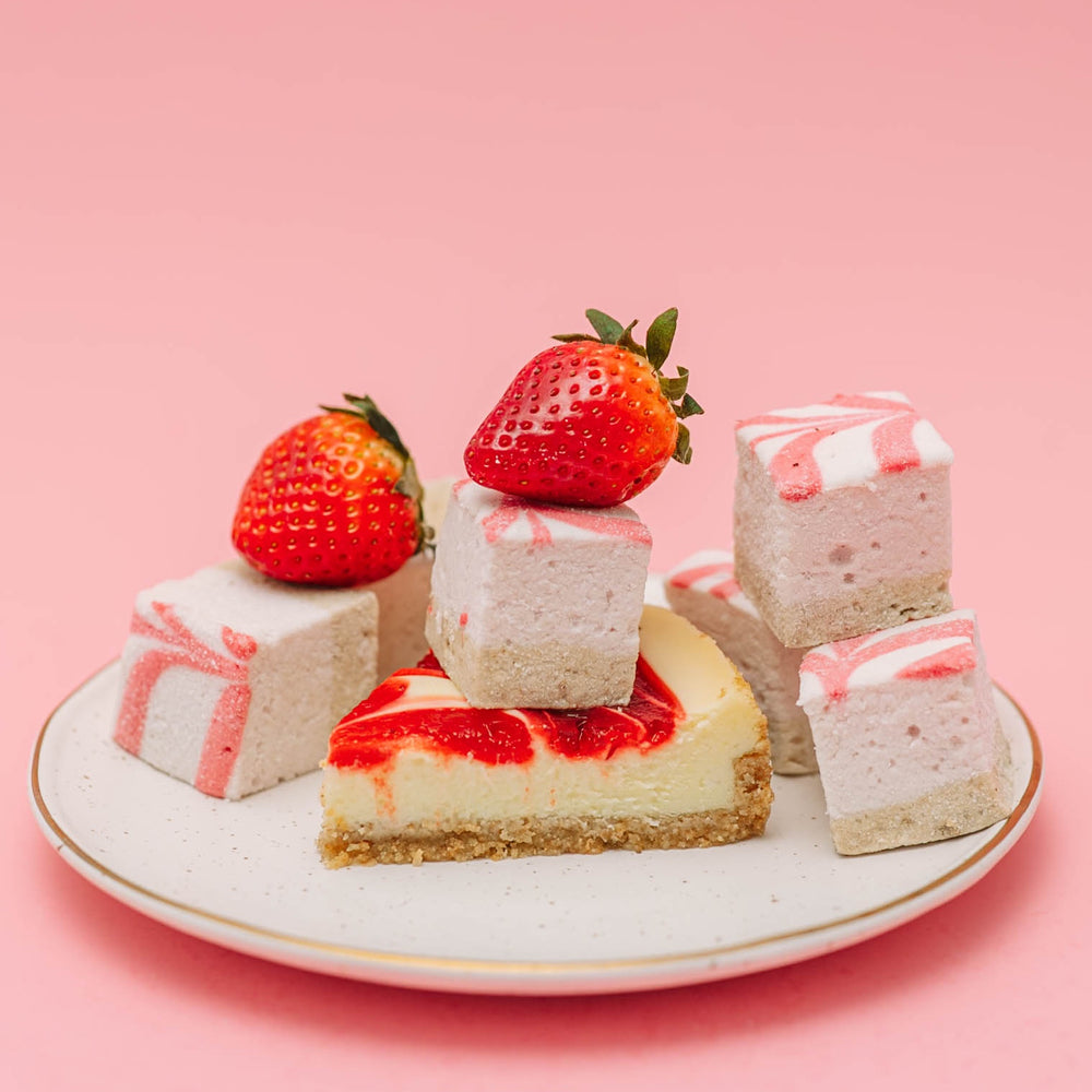 Decorative plate with strawberry cheesecake flavored homemade marshmallows on a pink background