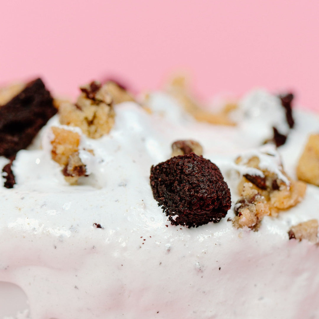 A close up shot of the brookie dough marshmallow creme with a pink background