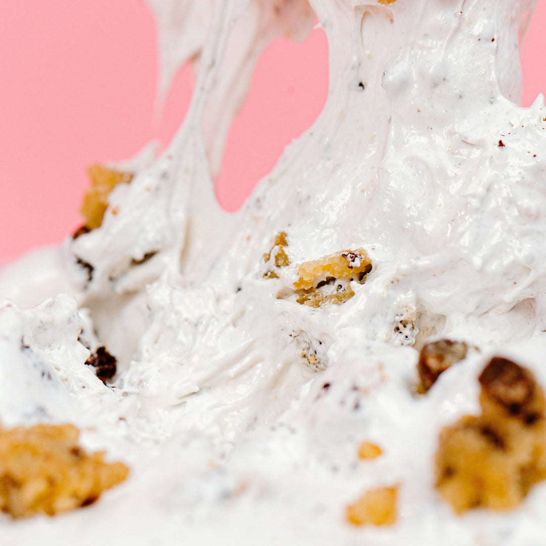 A really zoomed in shot of the Brookie Dough OMG showing how thick and stretchy it is with pieces of edible chocolate chip cookie dough and brownie mixed throughout