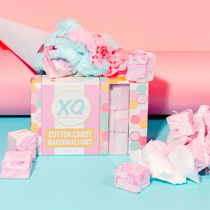 A box of Cotton Candy Marshmallows by XO Marshmallows, with visually appealing pink and blue marshmallow cubes displayed in front of the box.