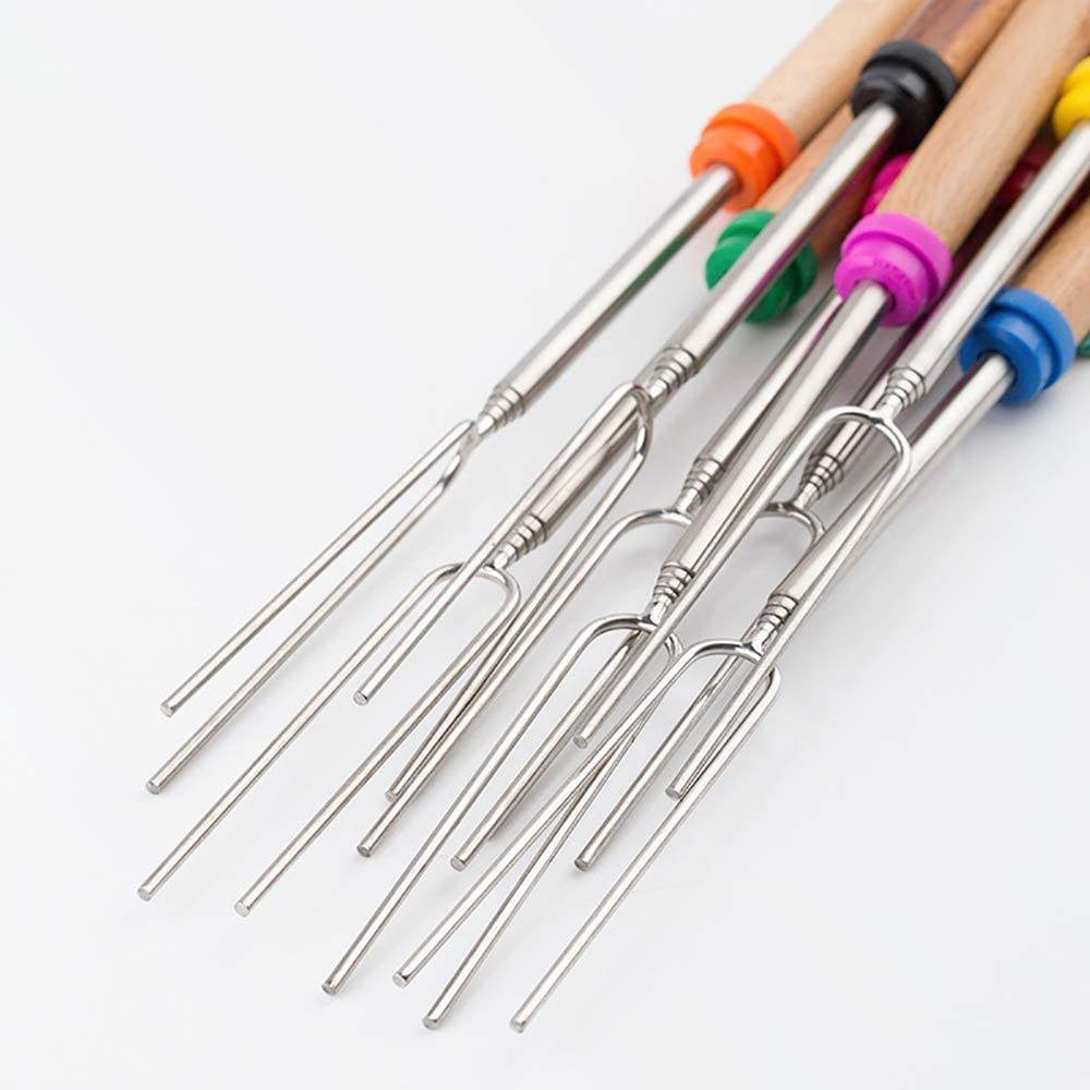 A set of marshmallow roasting skewers with colorful and wood handles against a white background.