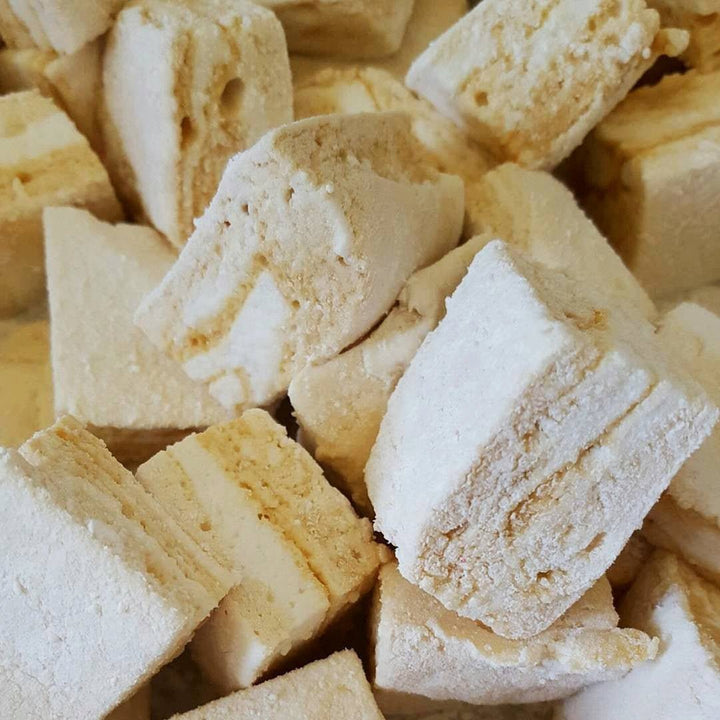 A super zoomed in photo of XO Marshmallow homemade salted caramel marshmallows showing the gourmet caramel sauce swirled throughout them.